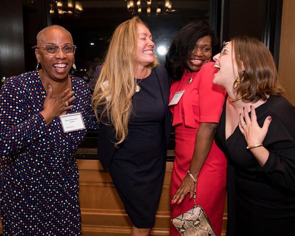 group of 4 diverse women having a great time at a Trial Academy event