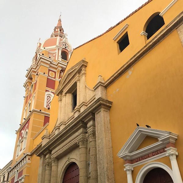 Spanish style, yellow stucco building with decorated steeple