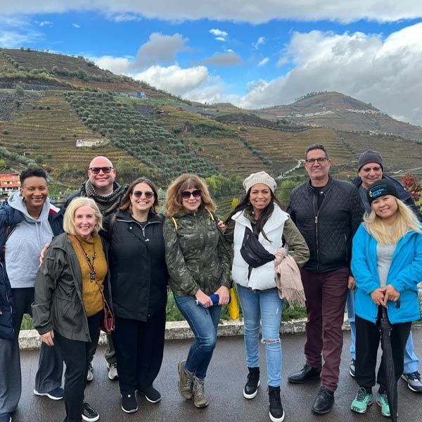 attendees posing infront of terraced hillside