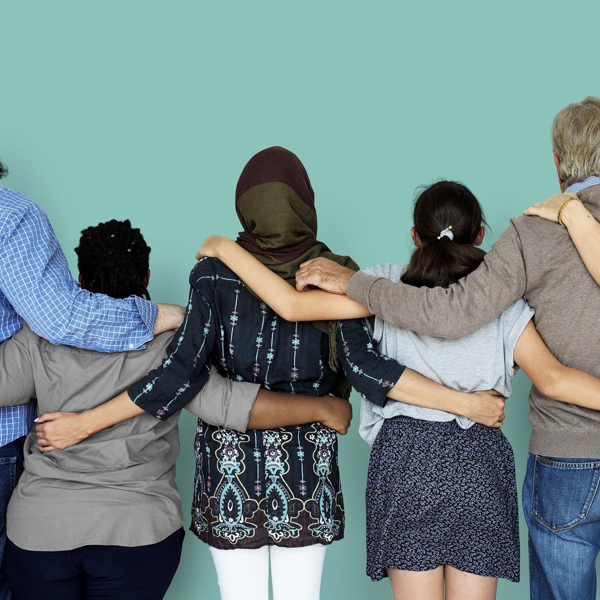 line up of adults of various demographics linking arms in support of each other