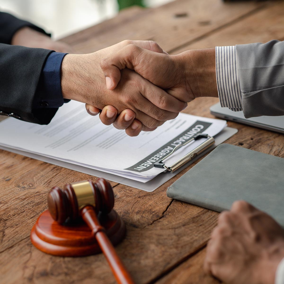 shaking hands over a court room table