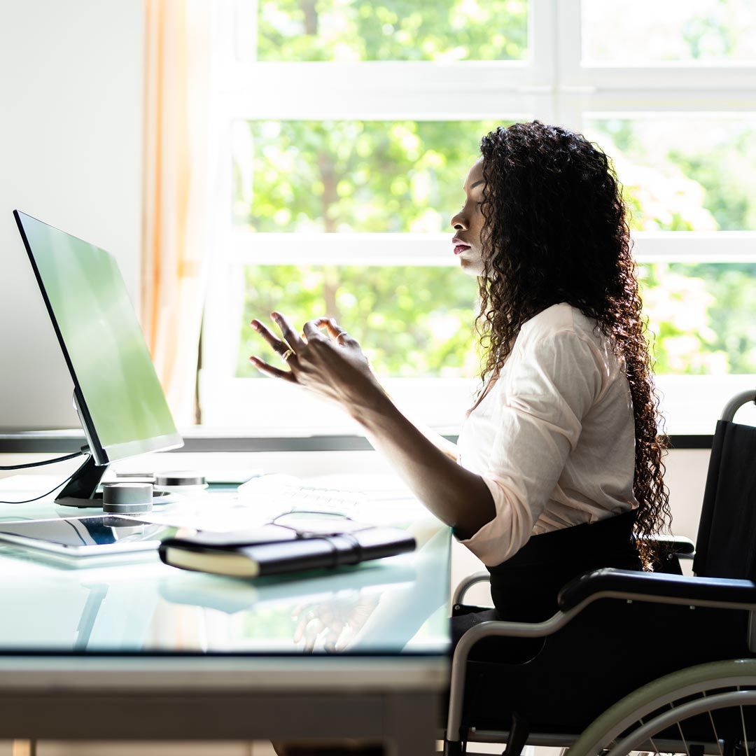 african american woman in wheelchair at a desk doing a mediation exercise