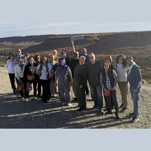 Trip participants posing in a desert landscape
